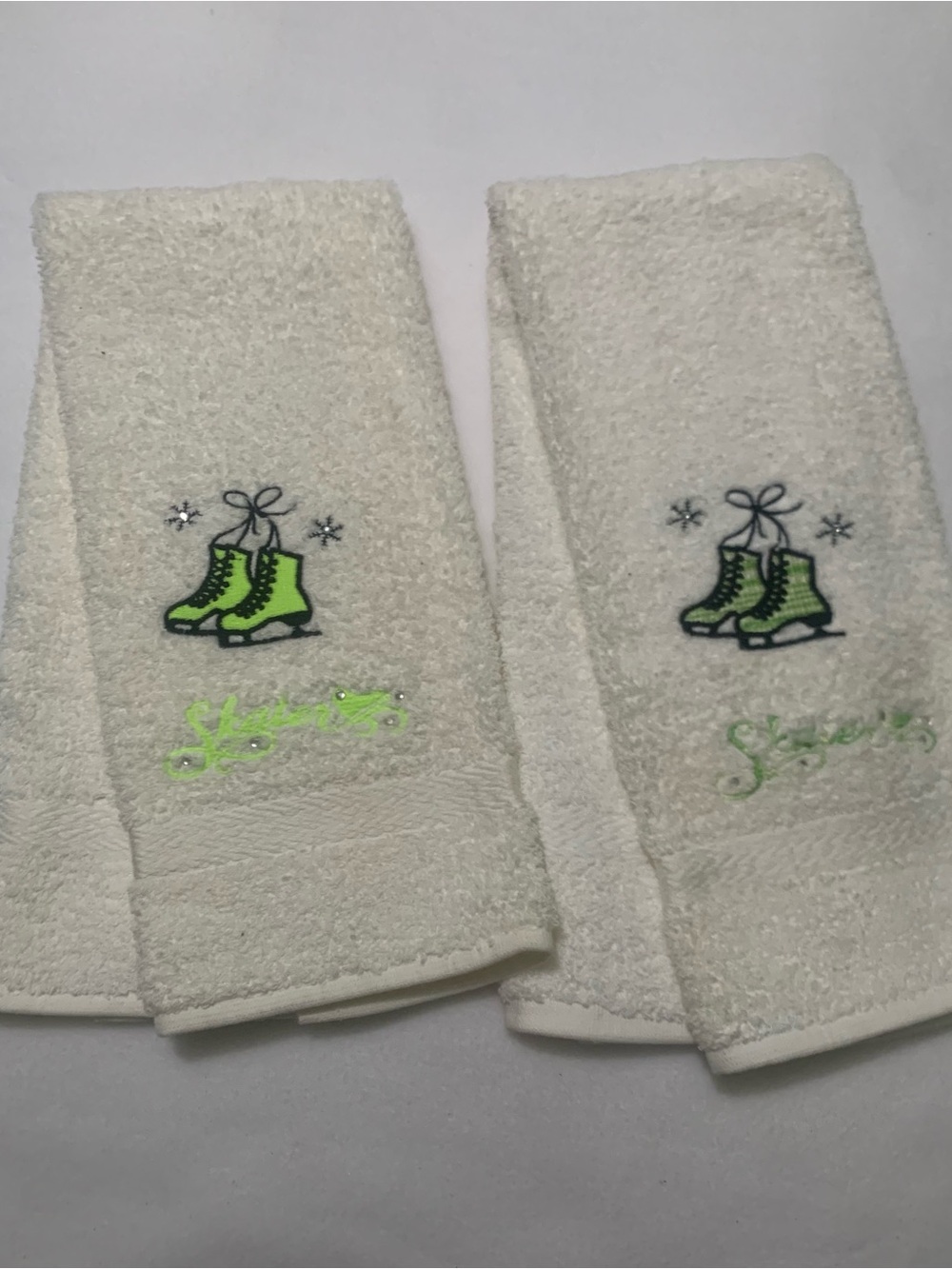 Mystique Boutique White
Hand Towels With Embroidered Green Ice Skates Design